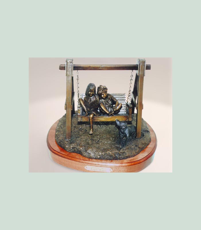 bronze sculpture of two children in a swing