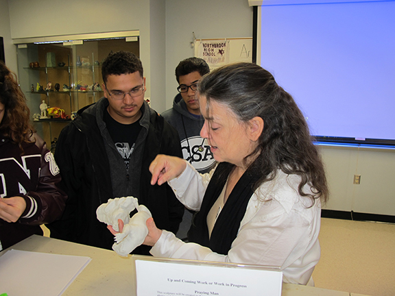 Artist Bridgette Mongeon discusses with students.