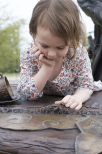 Bridgette Mongeon hides mice around Alice in wonderland.