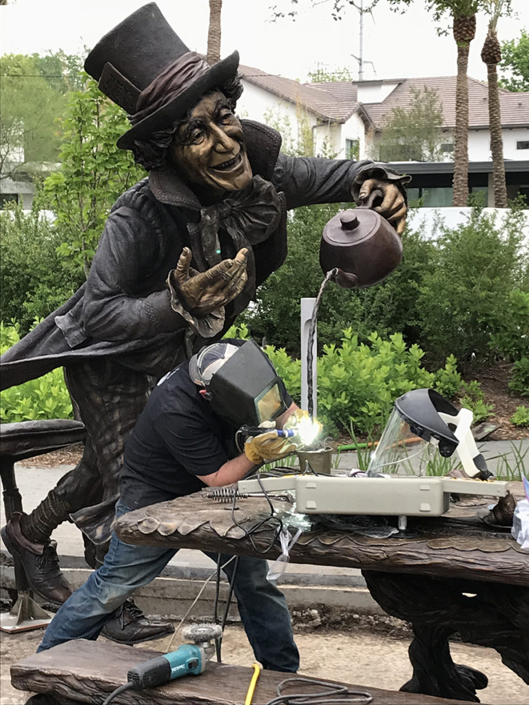 Mad Hatter is welded by Deep In The Heart Art Foundry. Bridgette Mongeon sculpted the Wonderland scene
