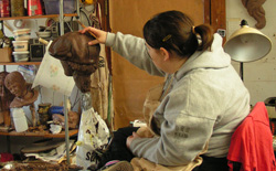 Creating a bronze life-size newsboy sculpture.