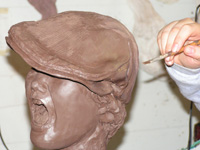 creating a life-size sculpture of a newsboy for bronze casting.