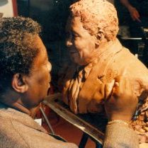 B. B. King signs the statue that Houston Texas artist created