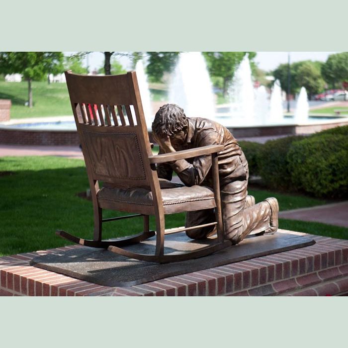 Bronze of praying man. Liturgical art.