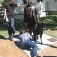 Installing a bronze sculpture of a man and dog. Texas artist Bridgette Mongeon.